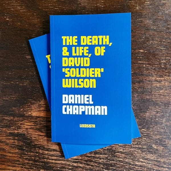 A photo of the cover of the book, which features the title in gold text and my name in white on a blue background